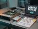 A clean tech workbench scene with an open server and a small hardware RNG