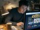 Photo of a worried young adult at a desk looking at an online slot