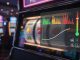 Photoreal close-up of a slot machine with a transparent analytics overlay showing low, medium,