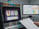 Photo of a modern slot machine under review in a lab, with a side